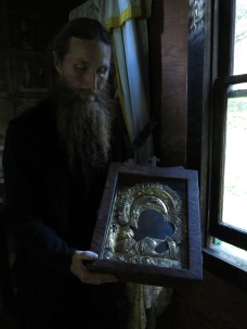 Fr Andrew of St Michael's Skete holding the Kaluga Icon of the Mother of God, in the Kaluga Chapel.
